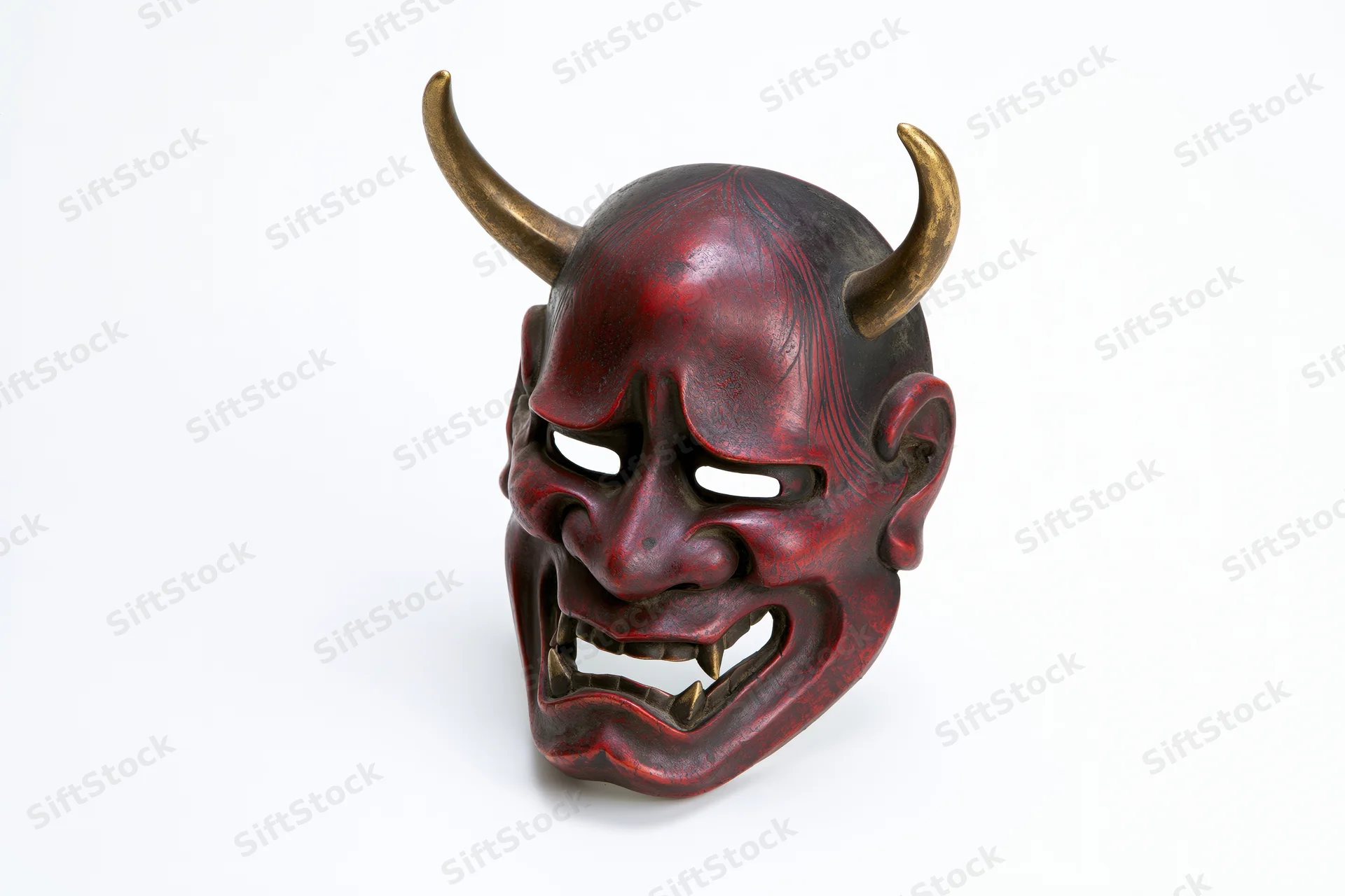 Traditional japanese hannya noh theater mask with horns and red lacquered surface on white background
