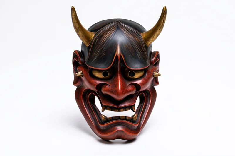 Traditional japanese hannya demon mask displayed face-forward on white background
