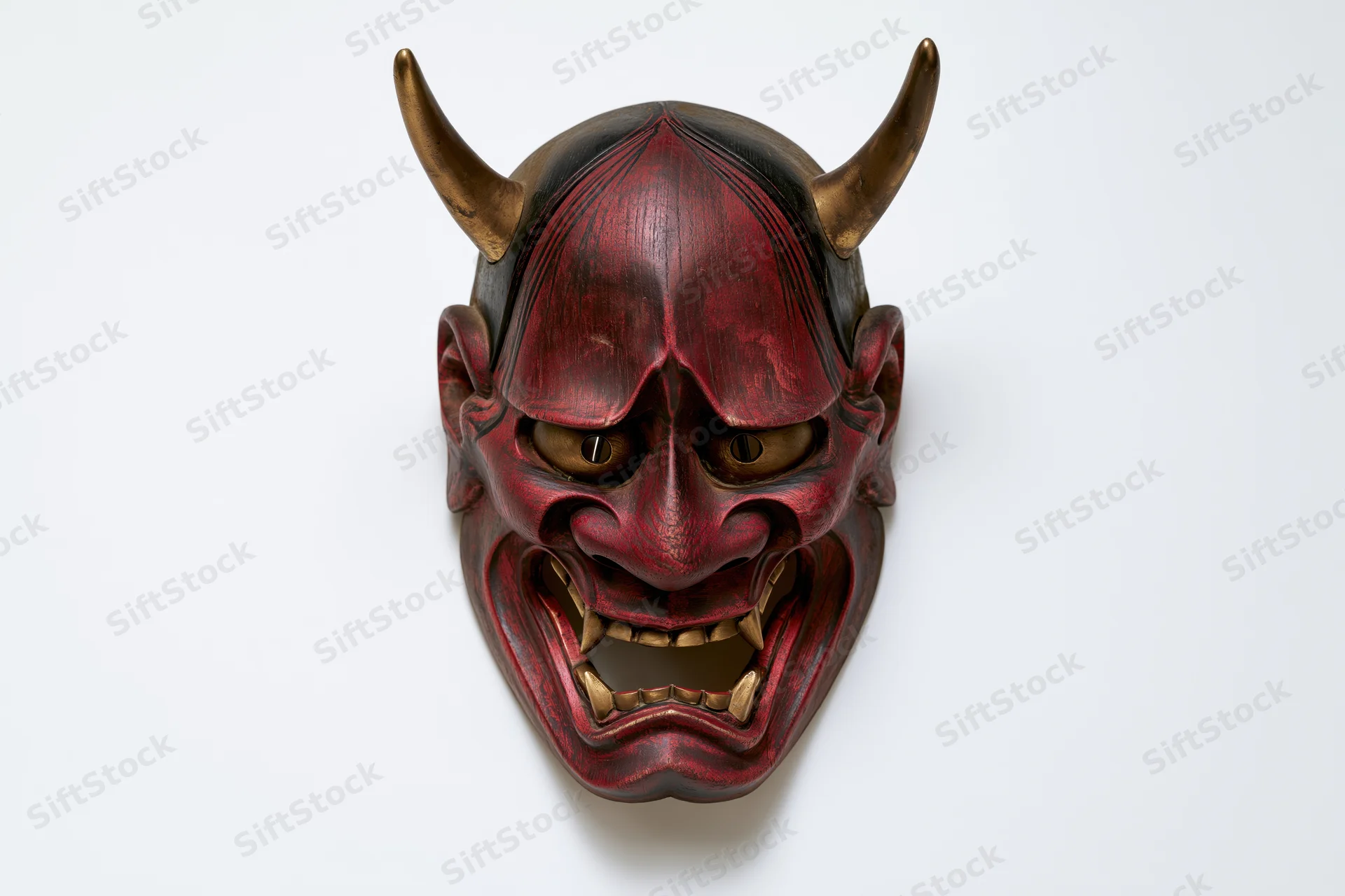 Traditional japanese hannya demon mask displayed face-forward on white background