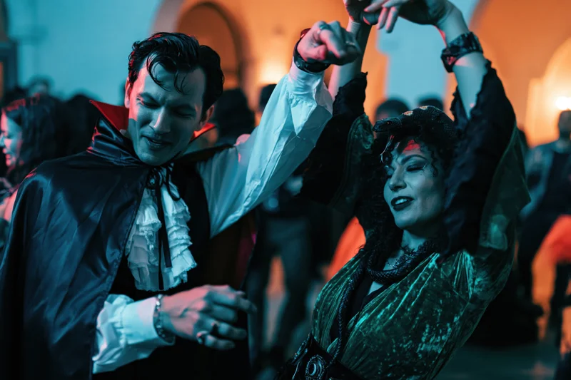 Couple in vampire costumes dancing at a halloween party