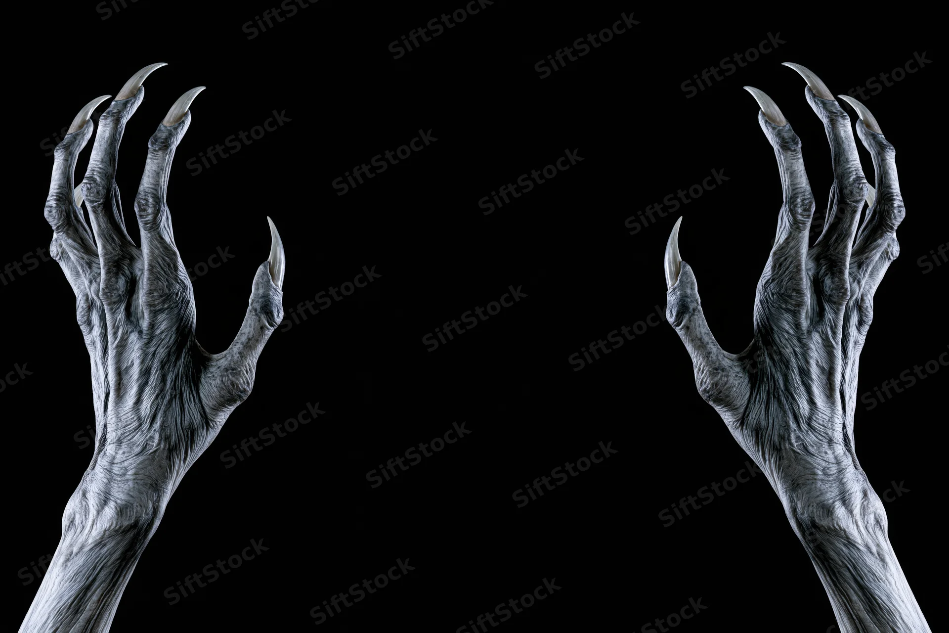 Two pale gaunt creature hands with long sharp claws reaching against black background