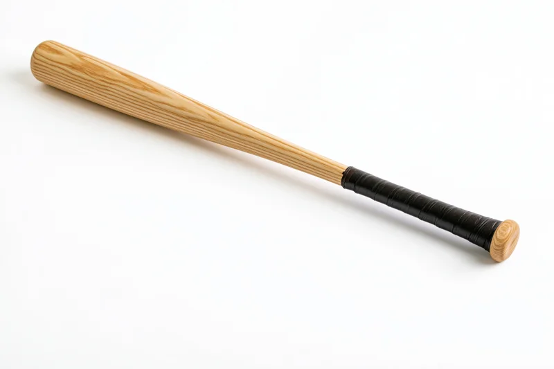 Wooden baseball bat lying diagonally on white surface