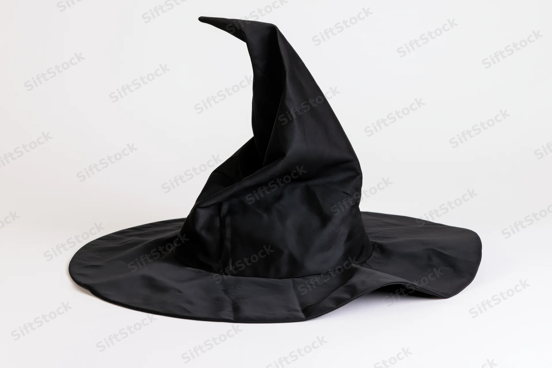 Black fabric witch hat with floppy pointed crown on white background