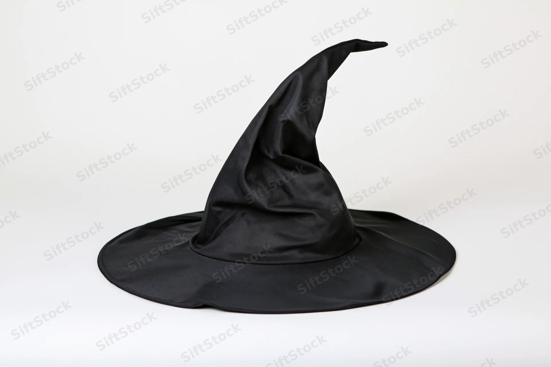 Black witch hat with crooked pointed crown and wide brim on white background