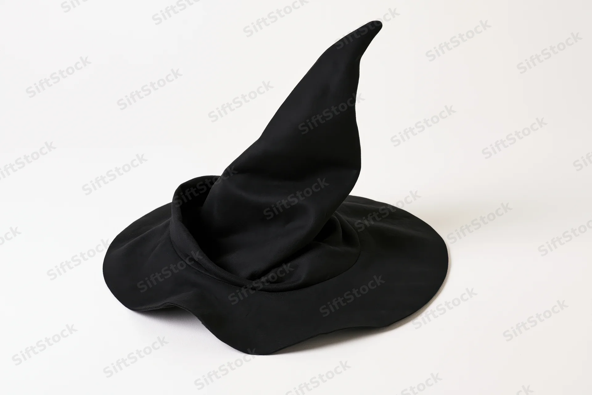 Black fabric witch hat with tall pointed crown and wide brim on white background