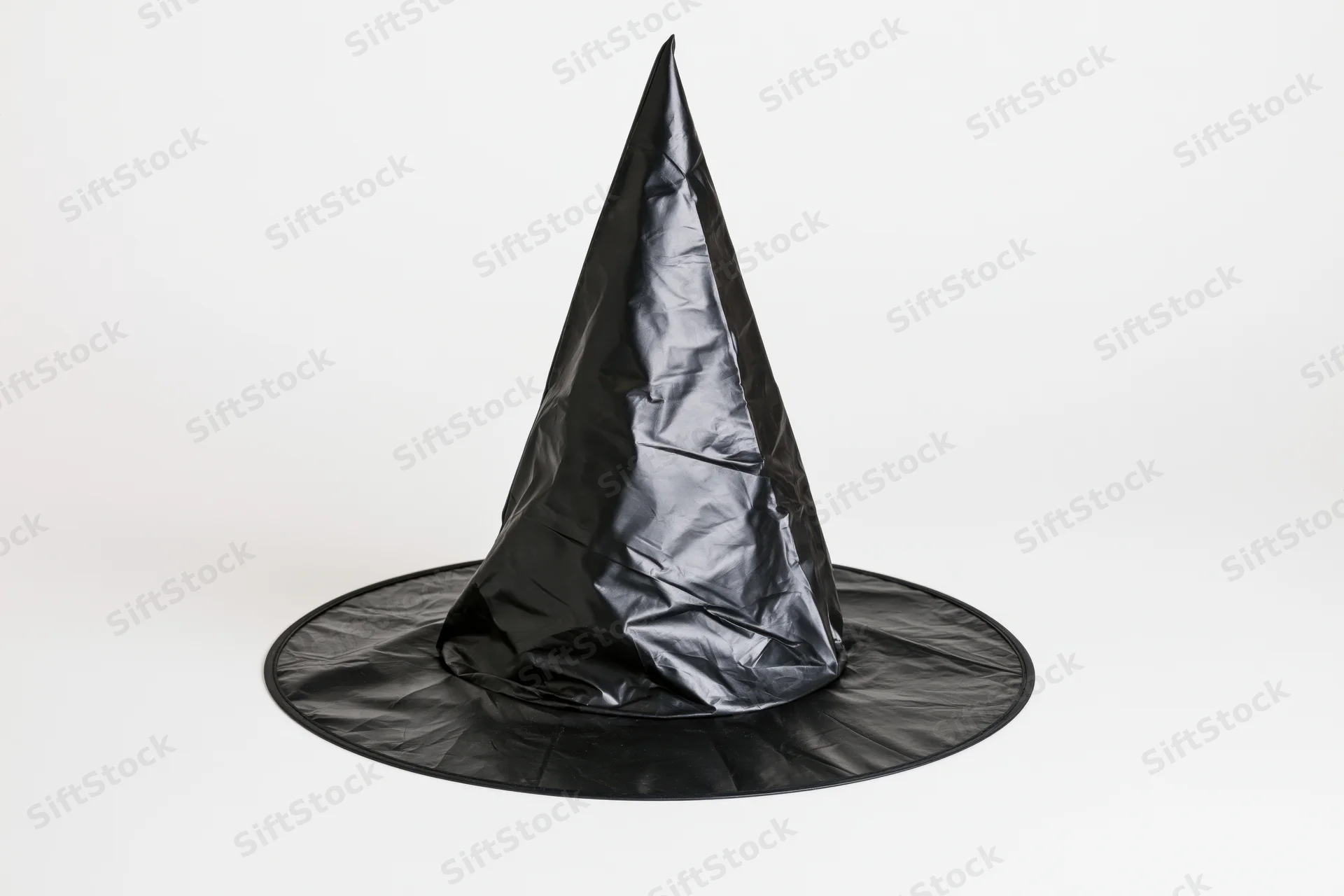 Black plastic witch hat standing upright on white background