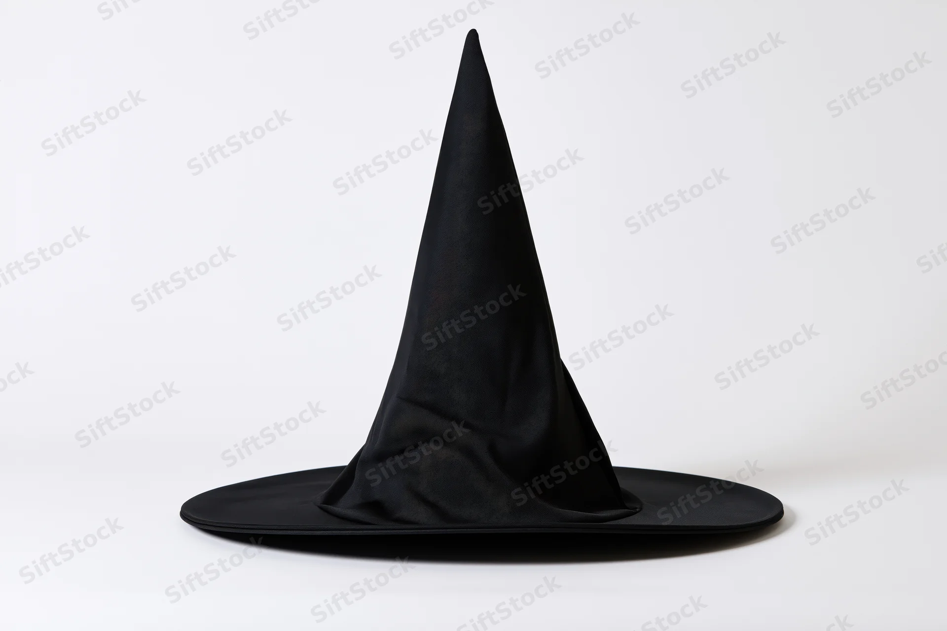Black witch hat with tall pointed cone and wide flat brim on white background