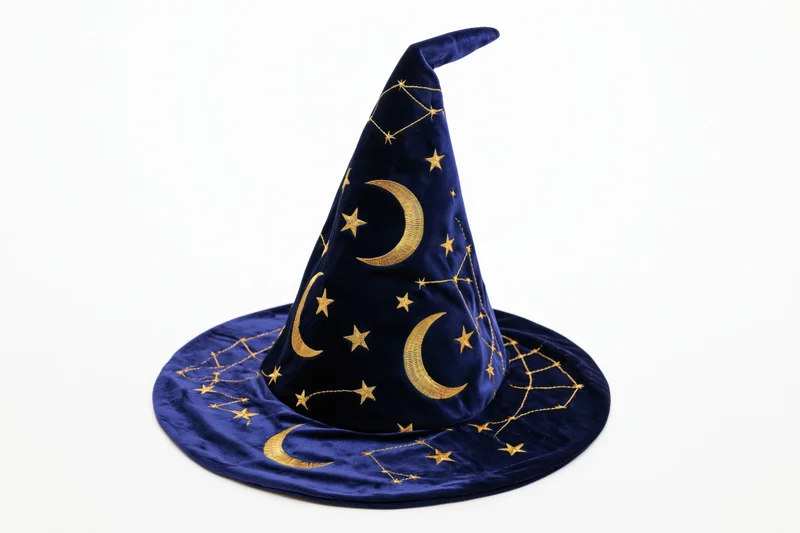 Navy velvet wizard hat with gold embroidered stars and moons on white background
