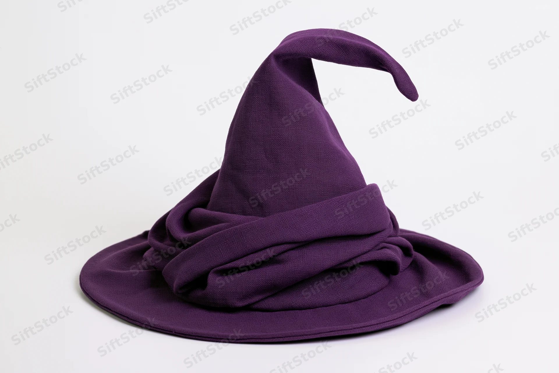 Deep purple fabric witch hat with tall curling tip isolated on white background