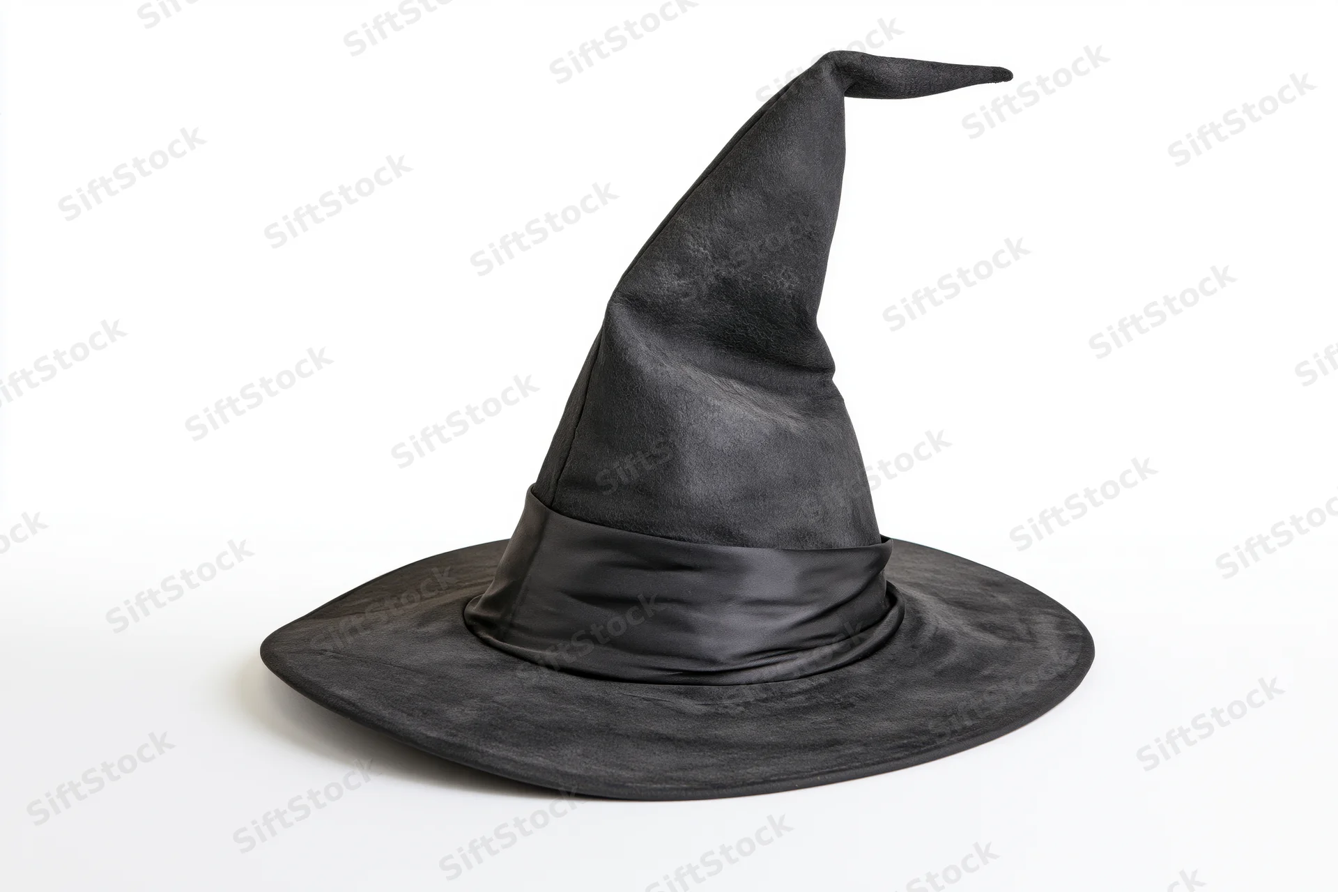 Worn black pointed witch hat tilted on white background