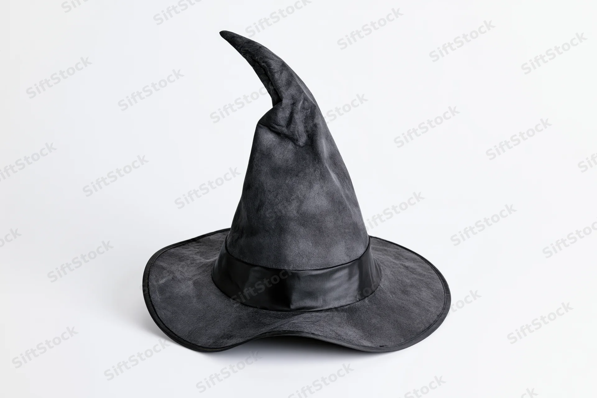 Black pointed witch hat tilted and worn, isolated on white background