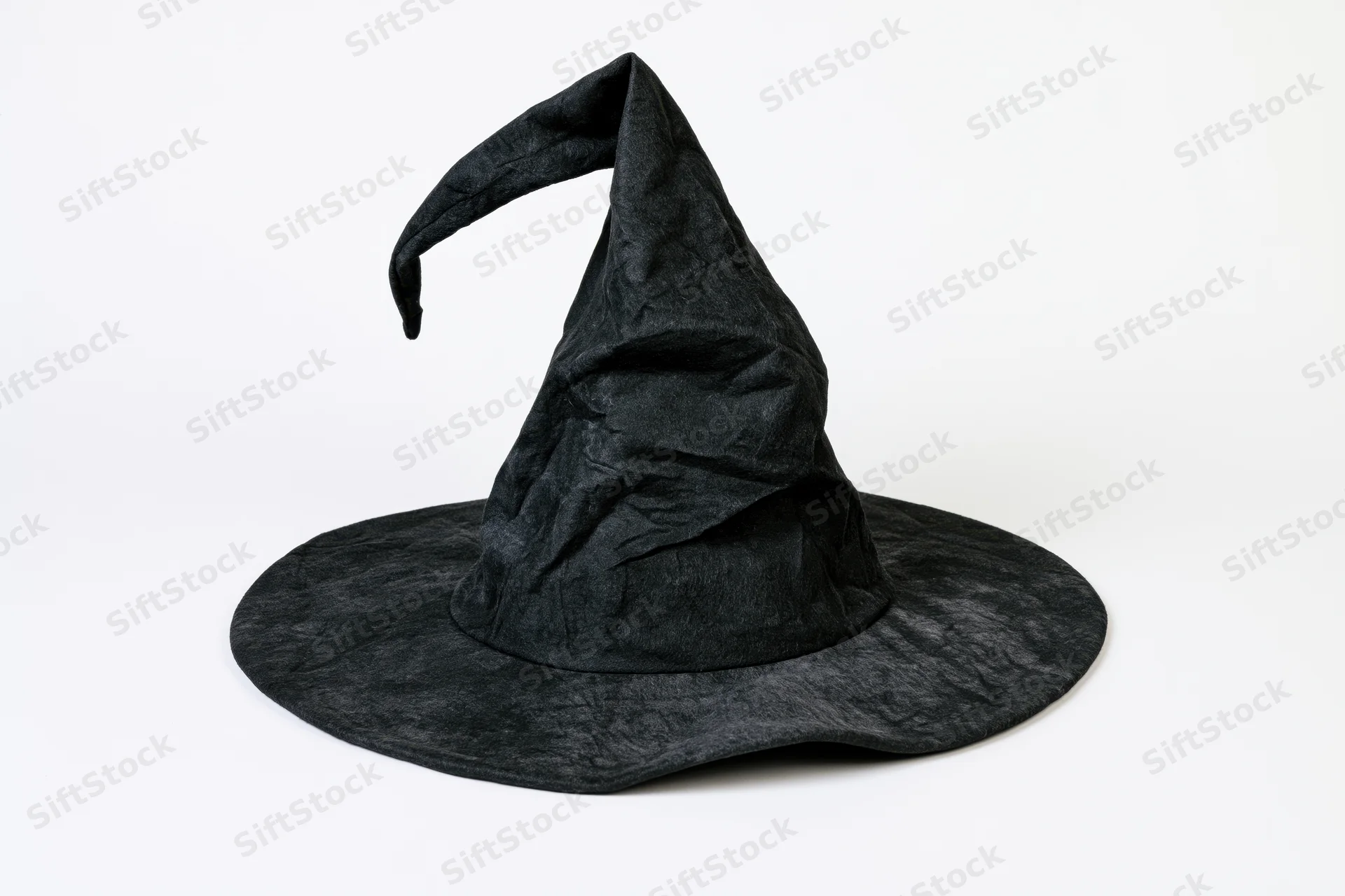 Black witch hat with bent drooping tip on white background