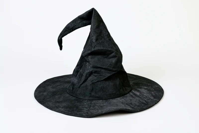 Black witch hat with bent drooping tip on white background