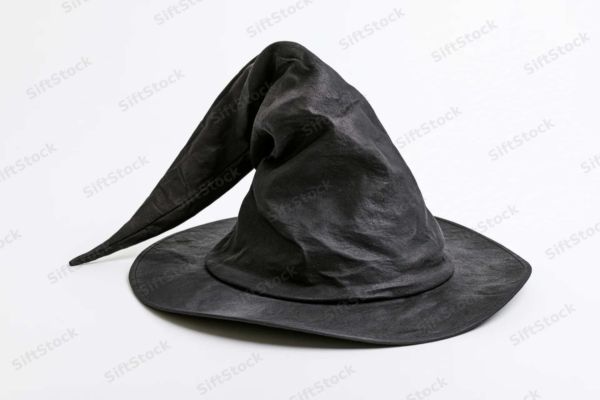 Worn black witch hat with bent drooping tip on white background