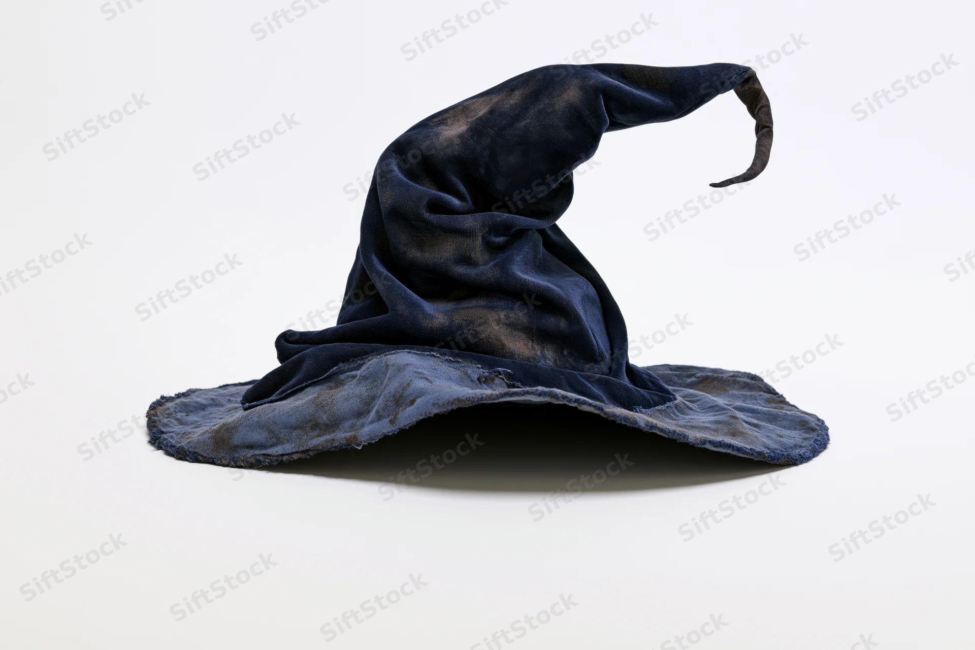 Worn black fabric wizard hat with tall curling pointed tip on white background