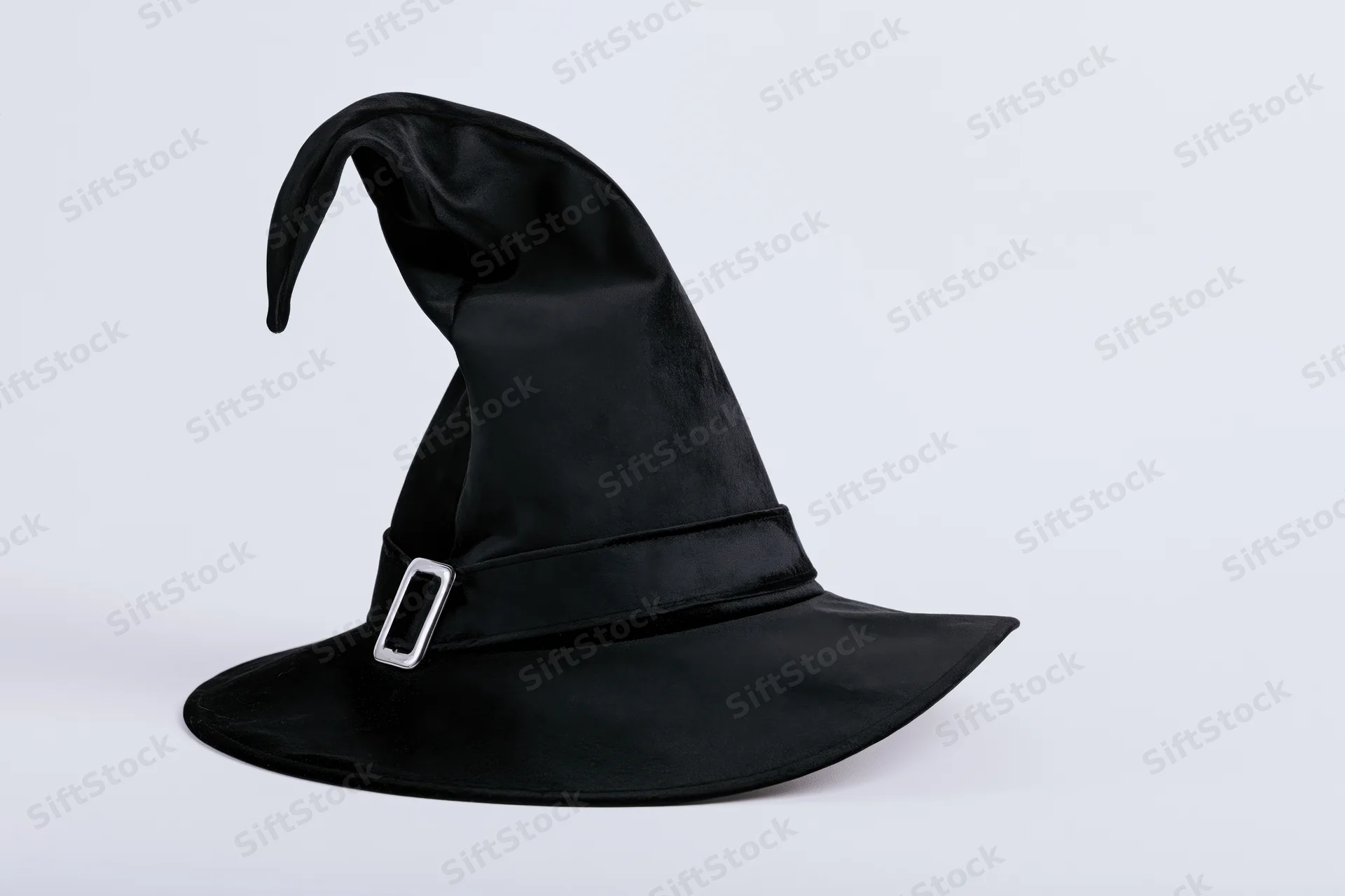 Black witch hat with curved pointed tip and silver buckle on white background