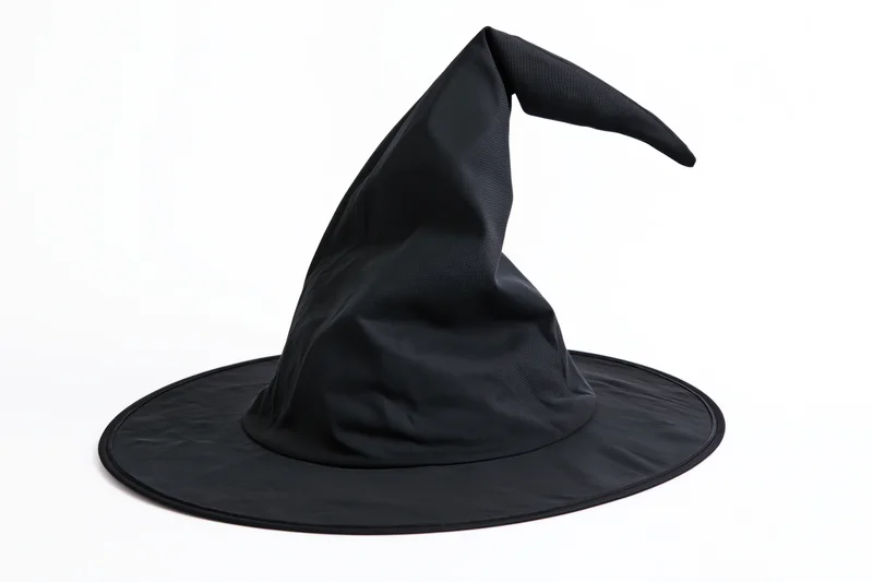 Black witch hat with tall pointed crown and wide flat brim isolated on white background