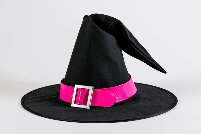 Black witch hat with wide flat brim and tall pointed crown on white background
