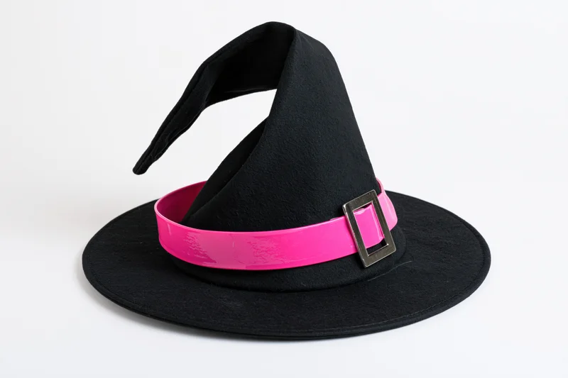 Black witch hat with wide flat brim and tall pointed crown on white background