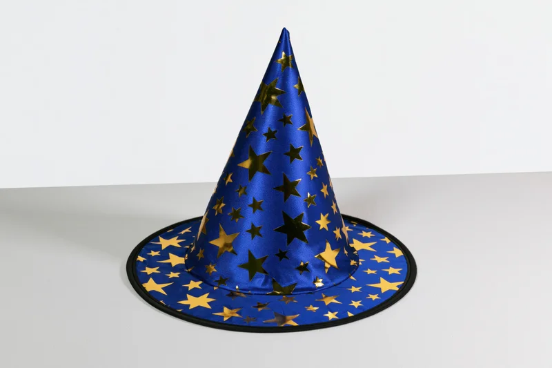 Blue wizard hat with gold foil stars sitting upright on a white surface
