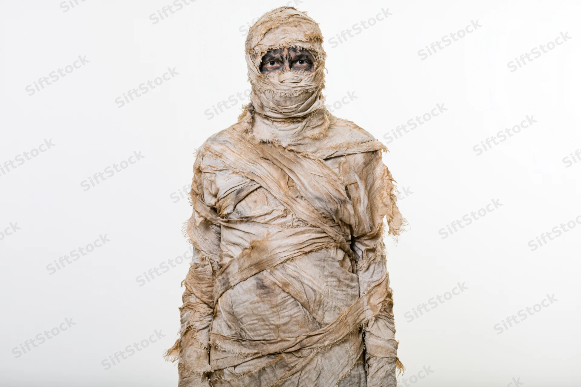 Person in full mummy costume standing upright against white background