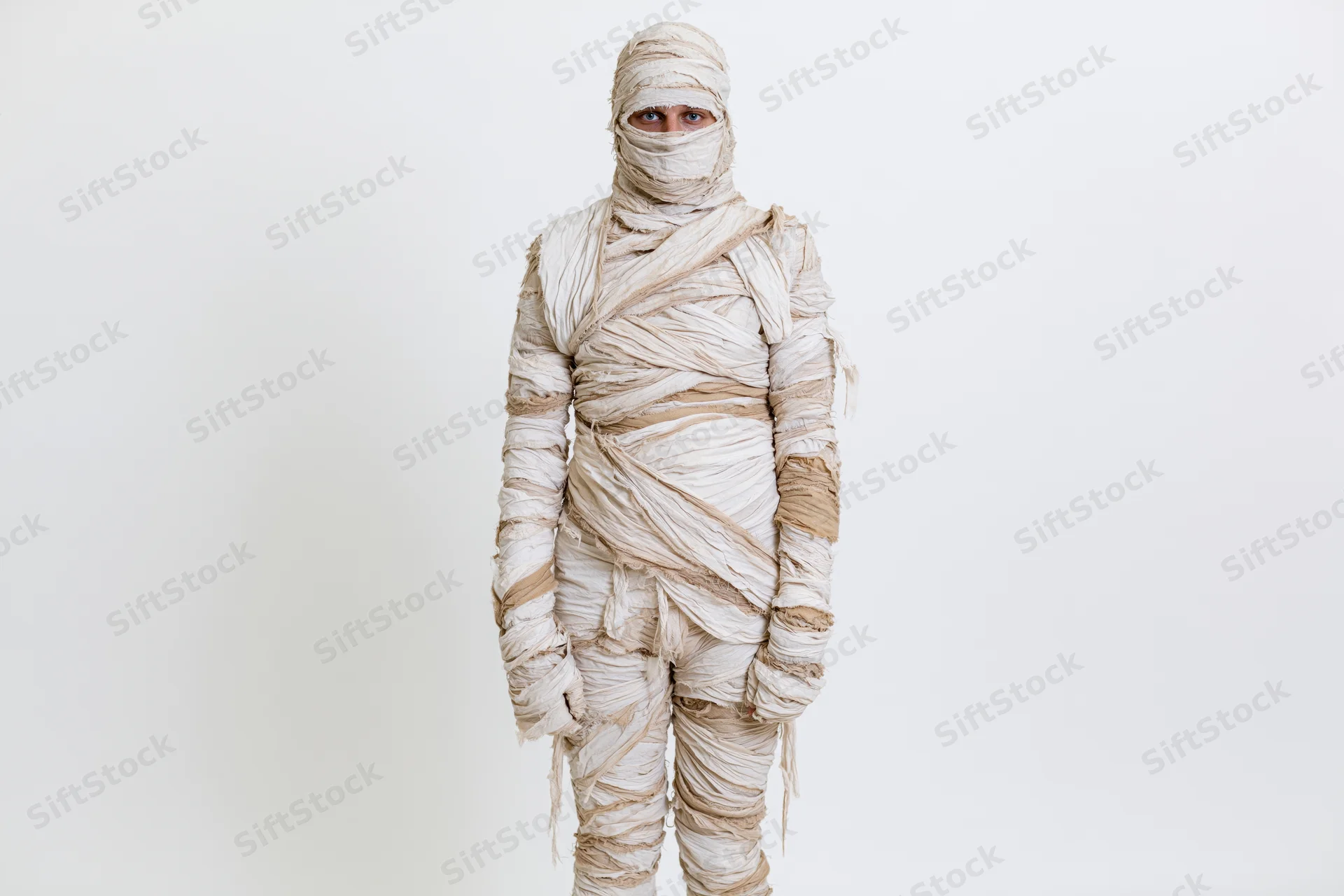 Person in full-body mummy costume standing upright against white background