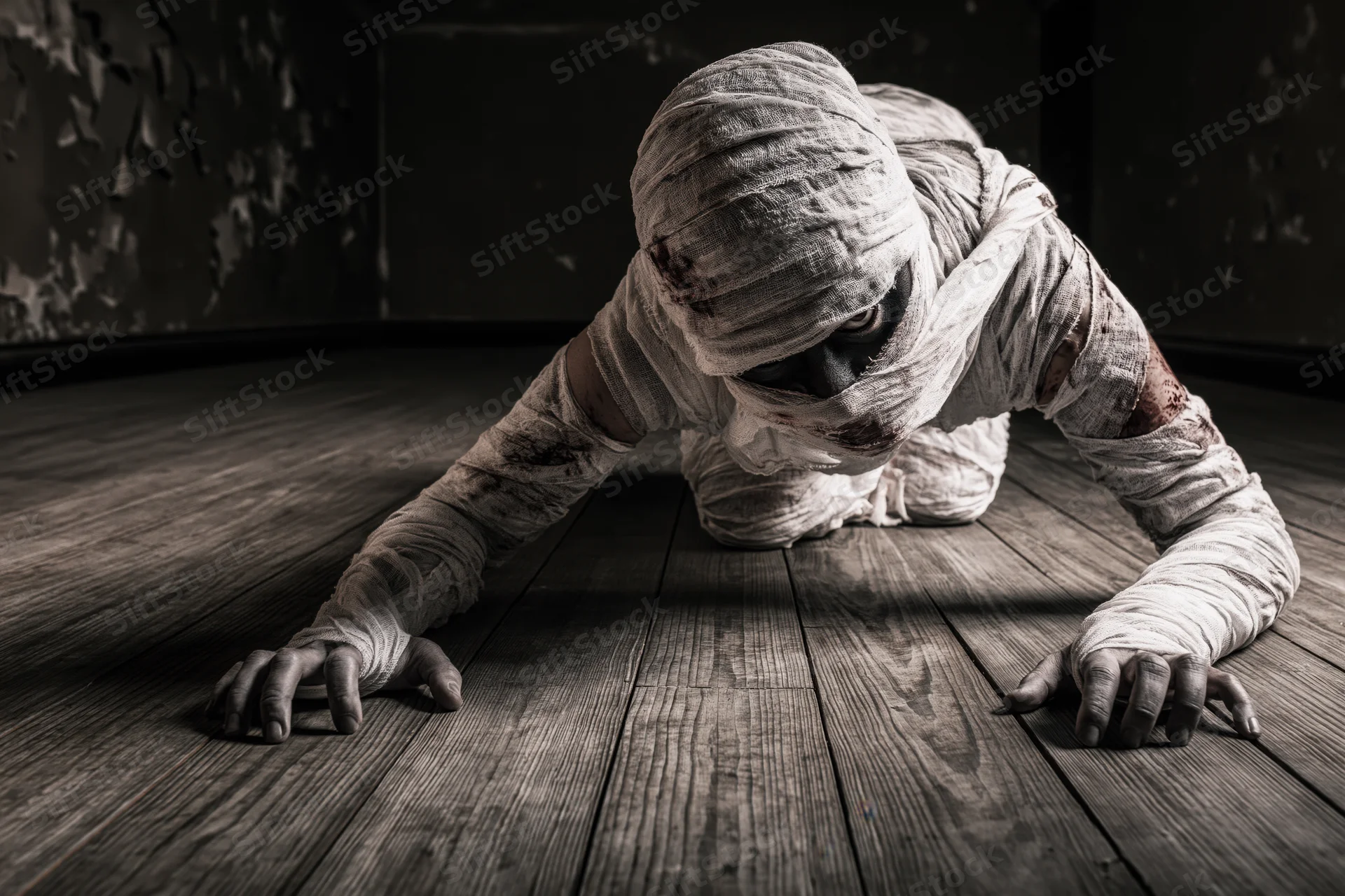 Mummy crawling on wooden floor in dark room