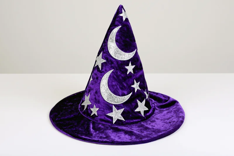 Purple velvet wizard hat with silver glitter moons and stars on white background