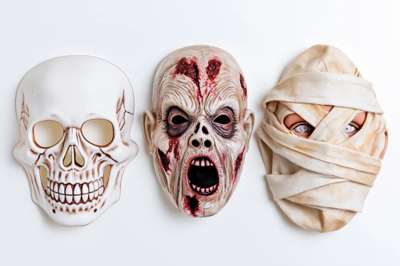 Three halloween rubber masks — skull, zombie, and mummy — arranged side by side on white background