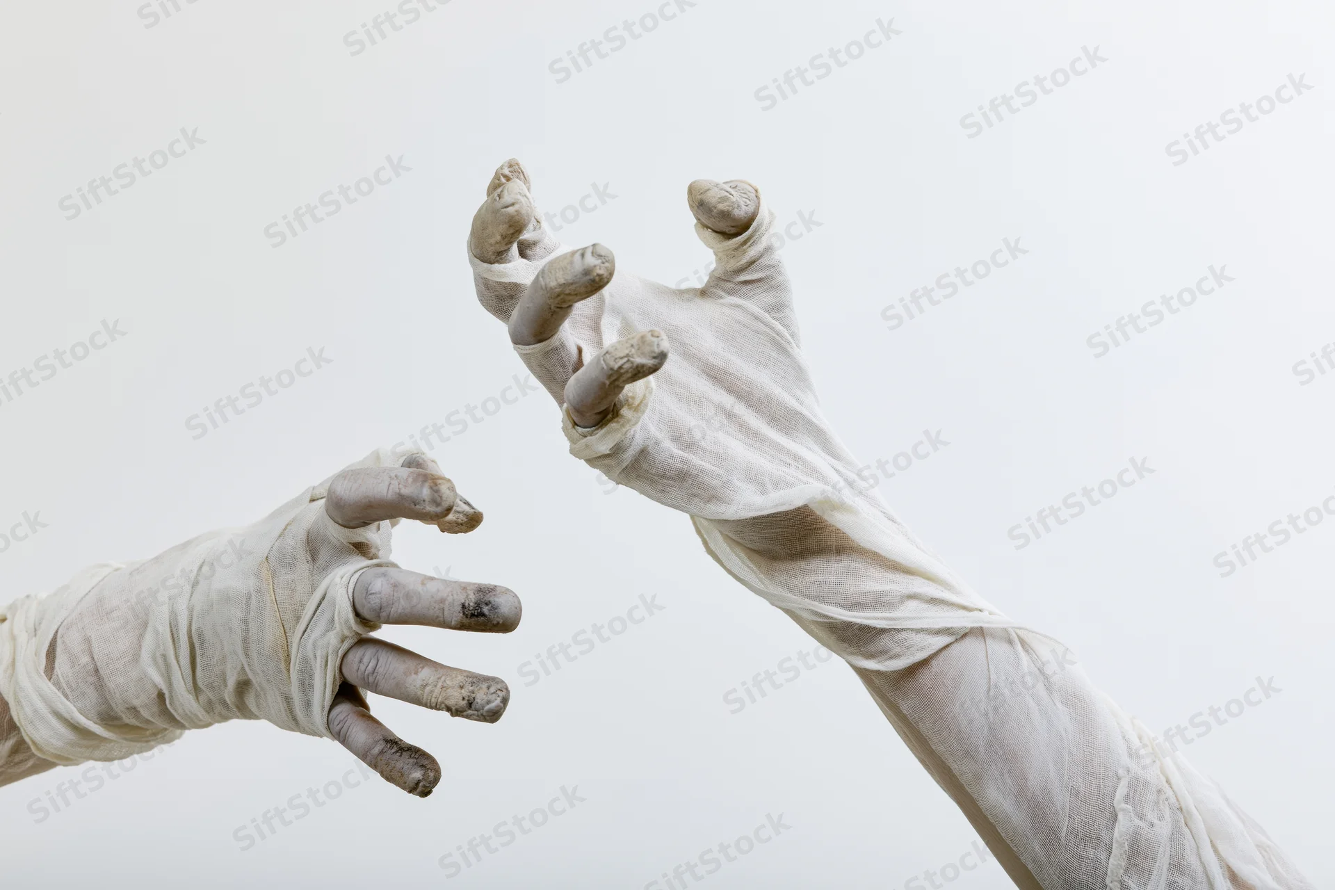 Two bandaged hands reaching toward each other against a white background