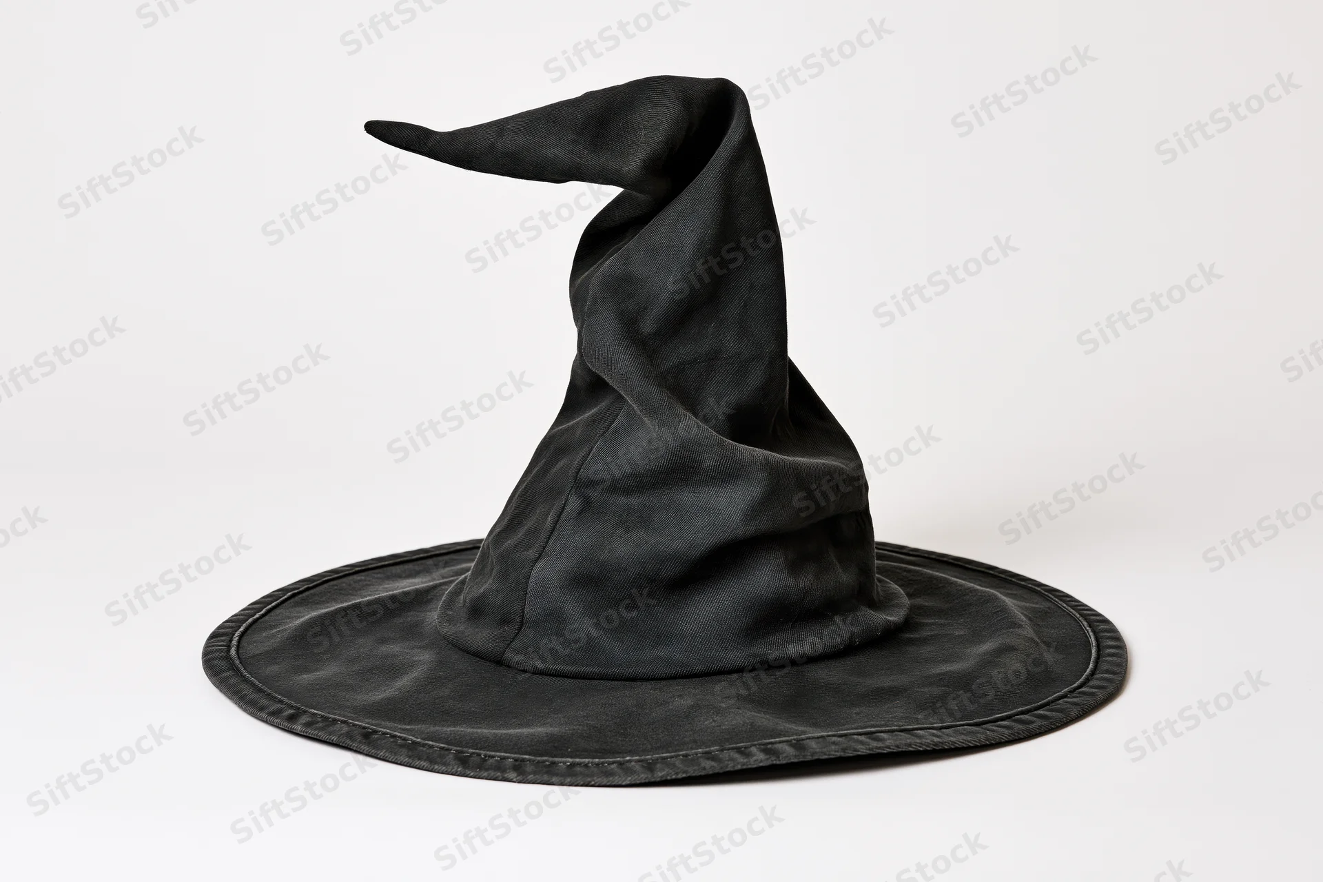 Black witch hat with crooked twisted tip on white background