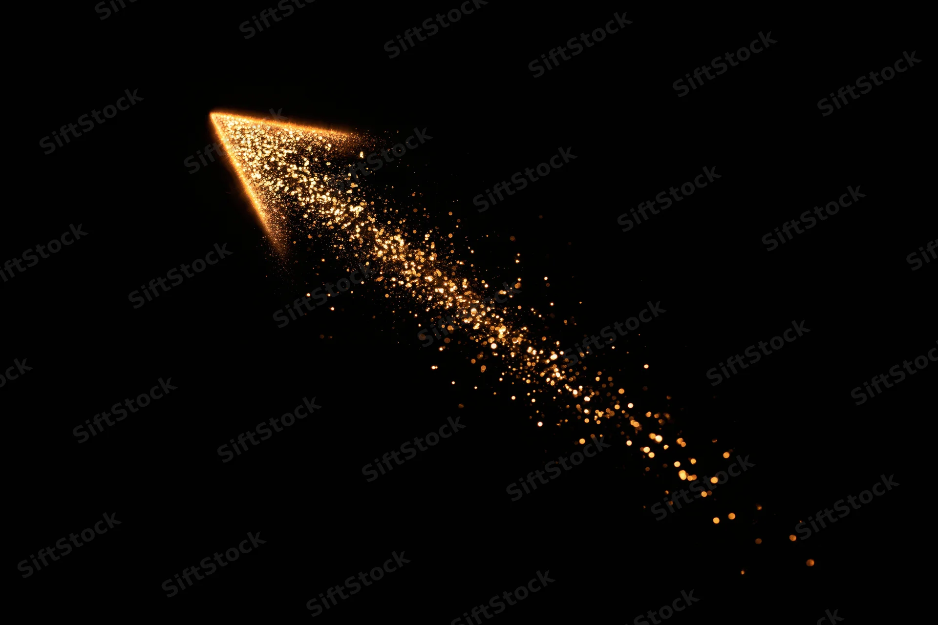 Glowing golden arrow made of scattered particles pointing upward against black background