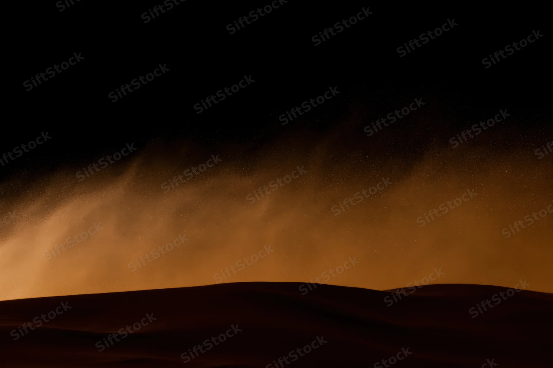 Massive sandstorm haboob rolling over desert dunes at night