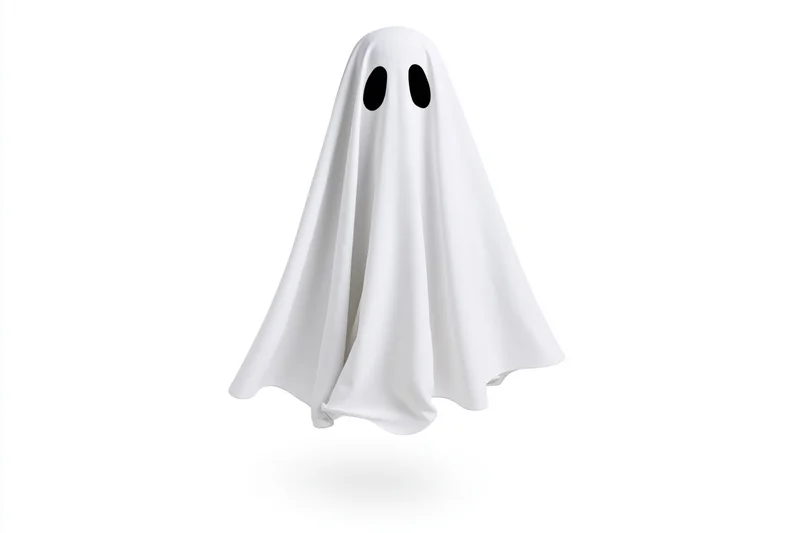 Floating ghost costume made from white sheet with black eye holes isolated on white background