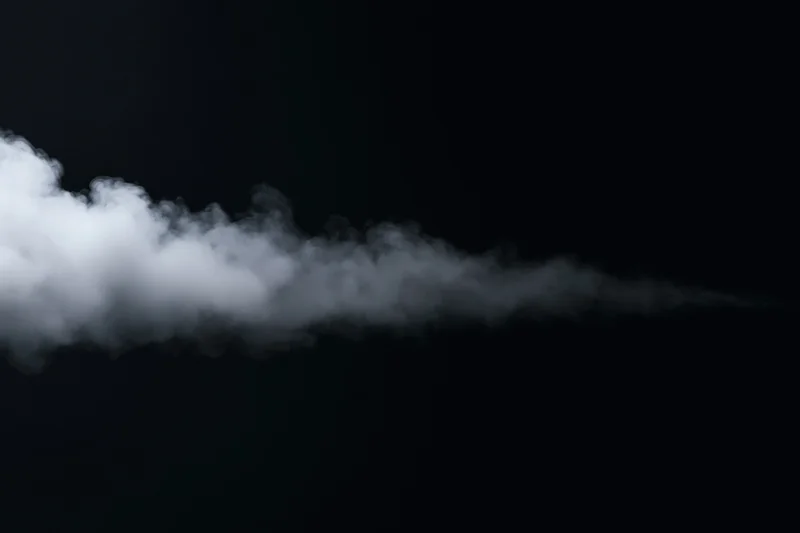 White smoke drifting horizontally against black background