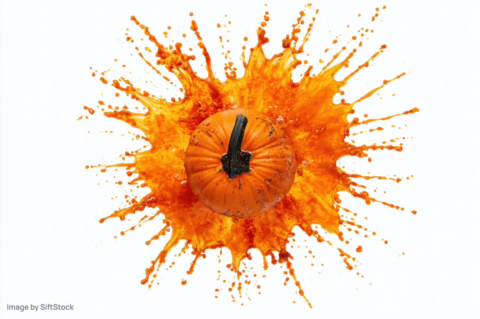 Small orange pumpkin surrounded by an explosive orange liquid splash on white background
