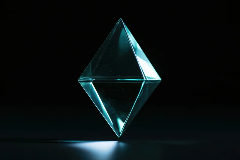 Translucent glass tetrahedron floating against a pure black background