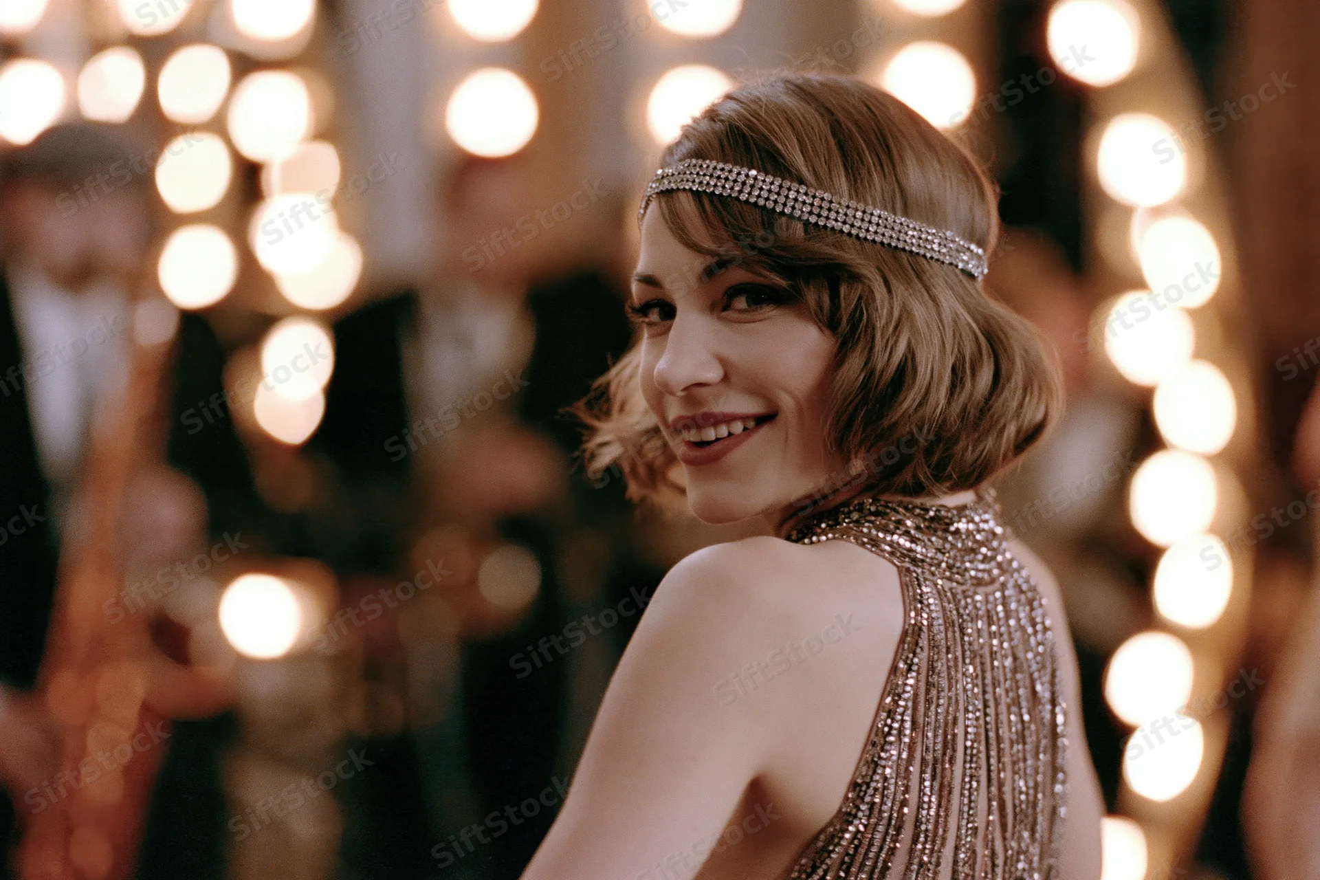 Young woman in 1920s beaded halter gown glancing back at camera at a jazz party
