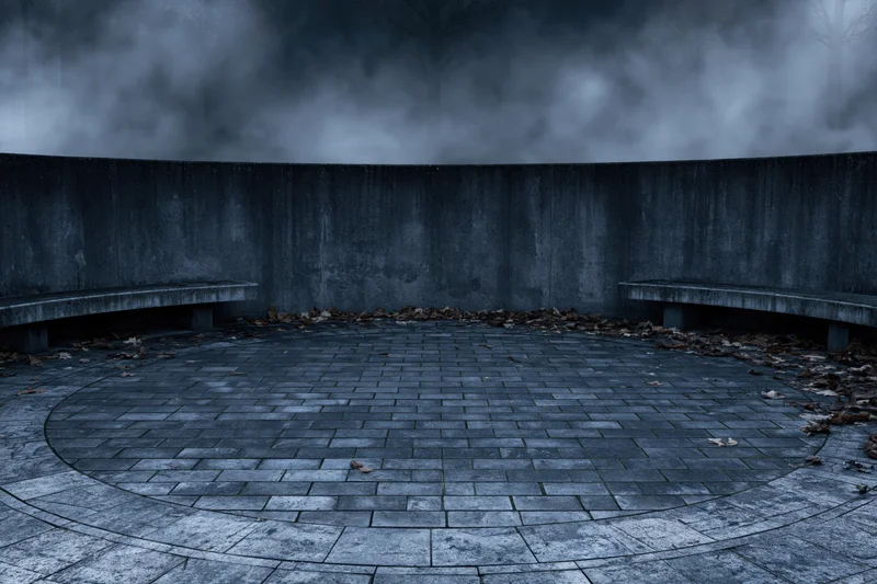 Circular stone courtyard at night with fog and benches, empty and abandoned