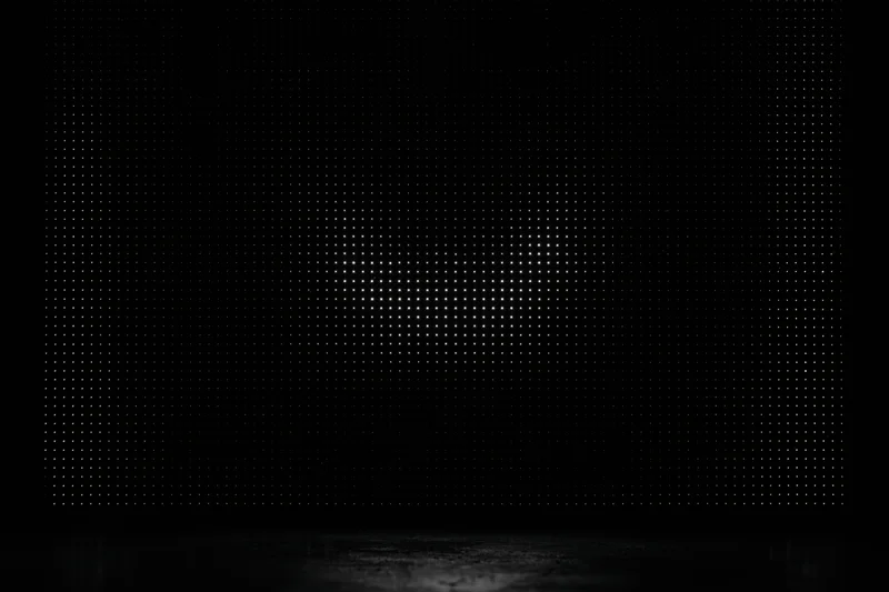 Glowing led dot matrix display panel in dark studio space with reflective floor