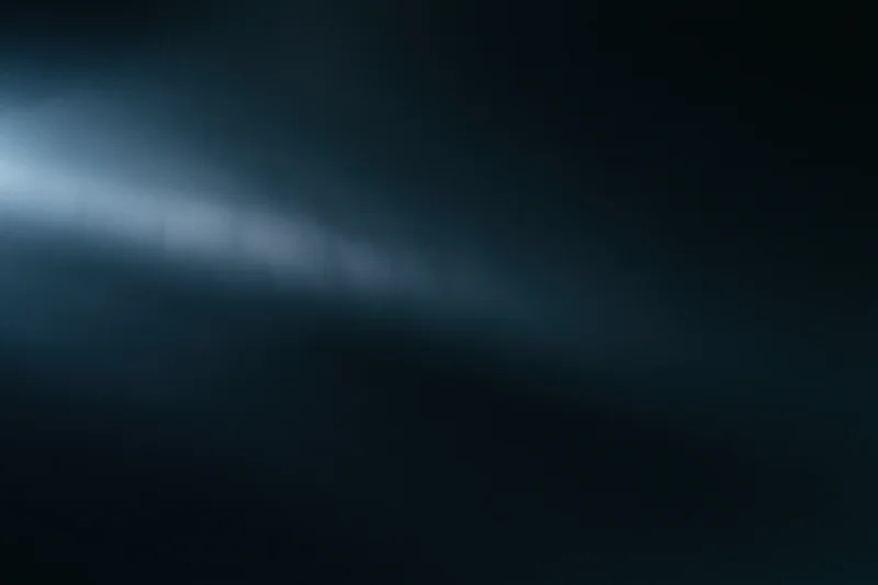 A diffused beam of cool blue light cutting through a dark atmospheric background