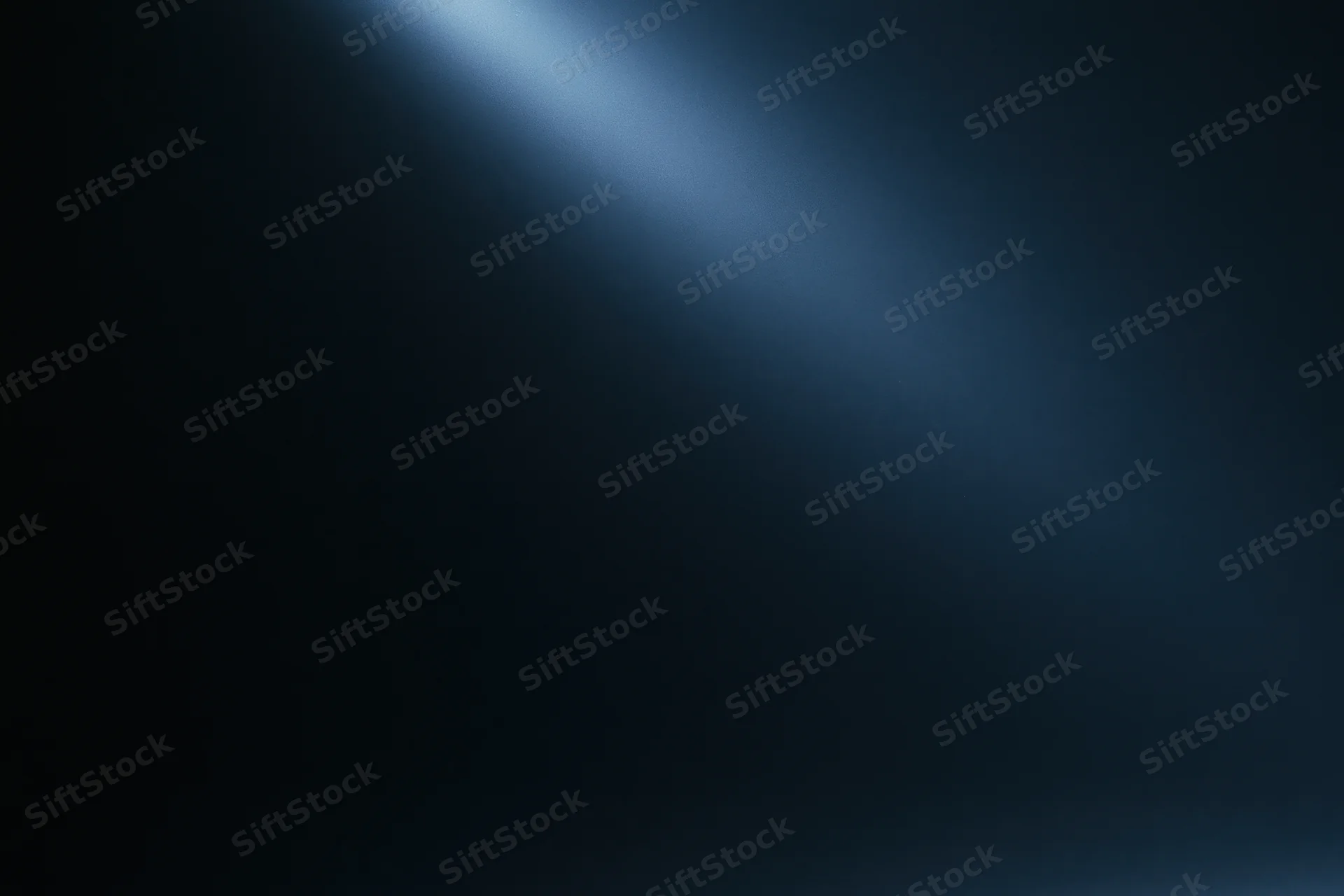 A single diffused beam of cool blue light on a dark abstract background with copyspace