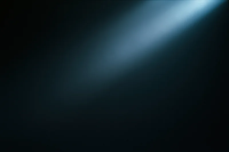 A single diffused beam of cool blue light on a dark abstract background with copyspace