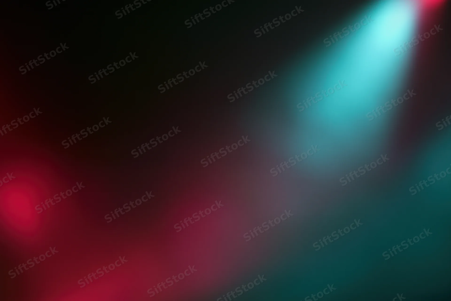 Abstract stage lighting with red and teal bokeh effects in a dark setting