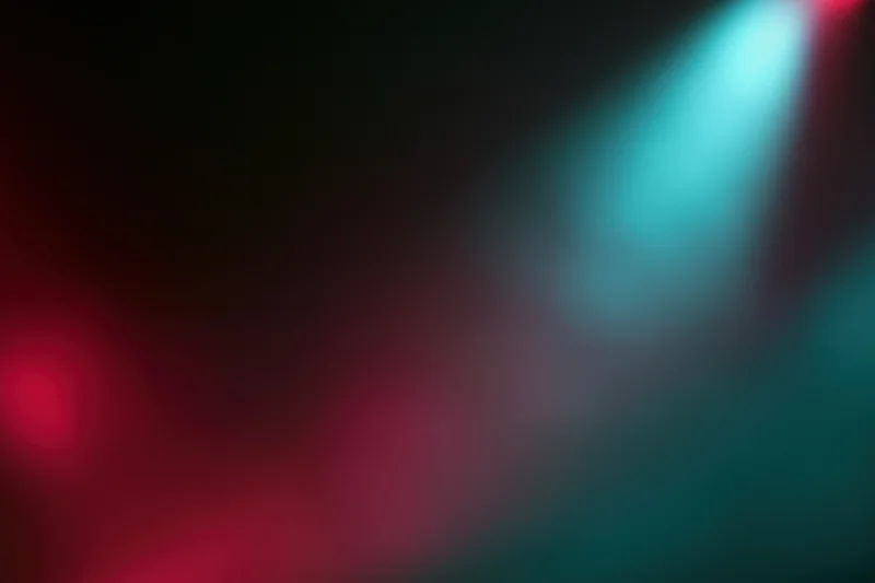 Abstract stage lighting with red and teal bokeh effects in a dark setting