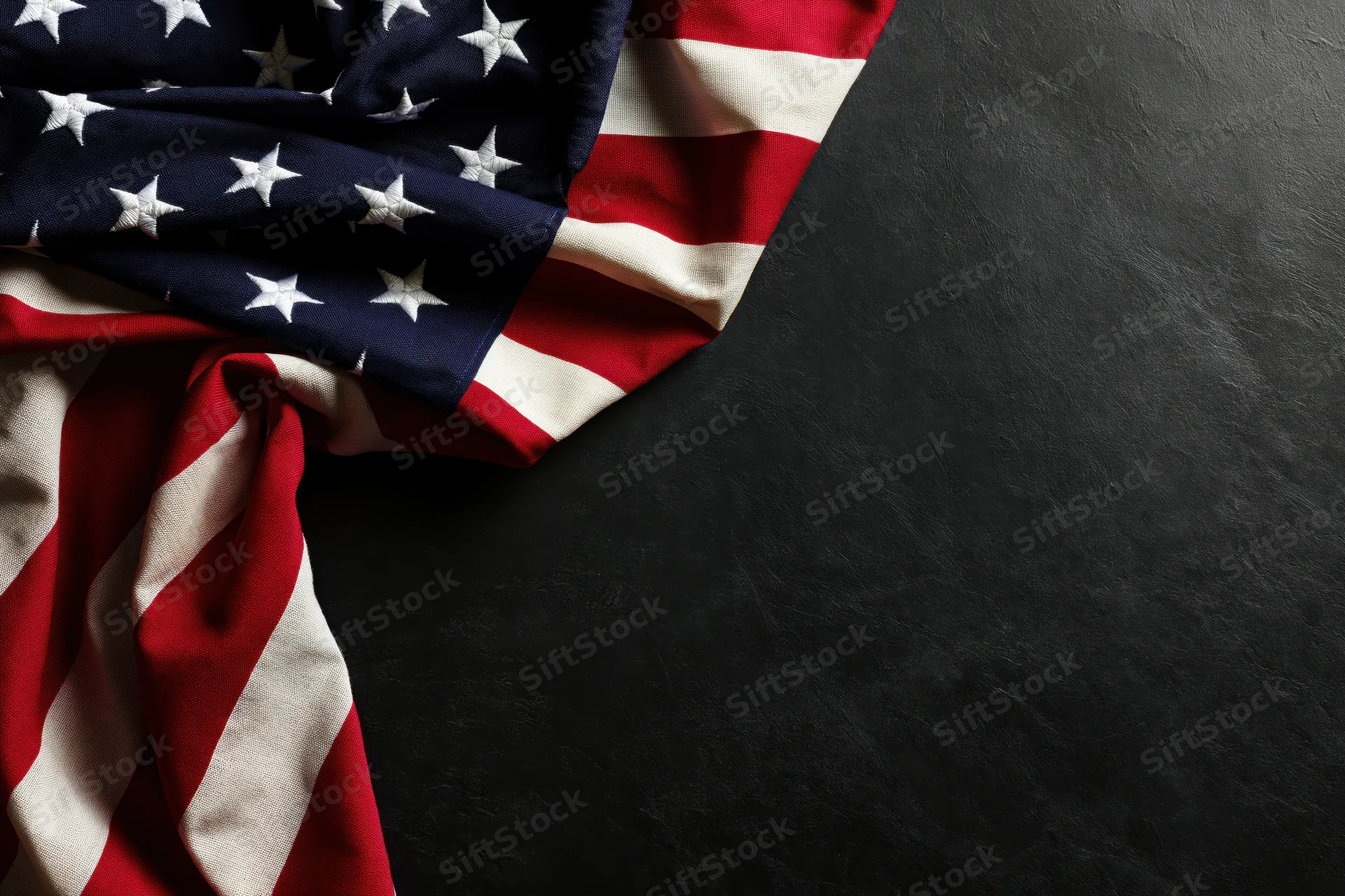 American flag draped on dark surface with copyspace