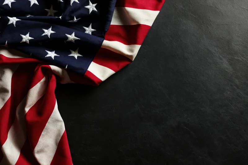 American flag draped on dark surface with copyspace