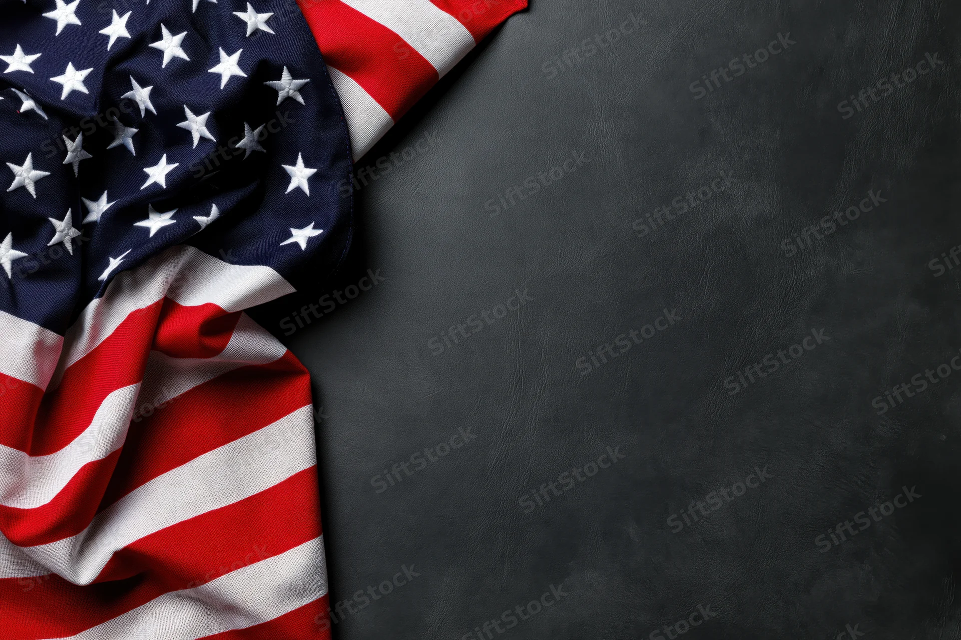 American flag draped in corner on dark textured surface with copyspace