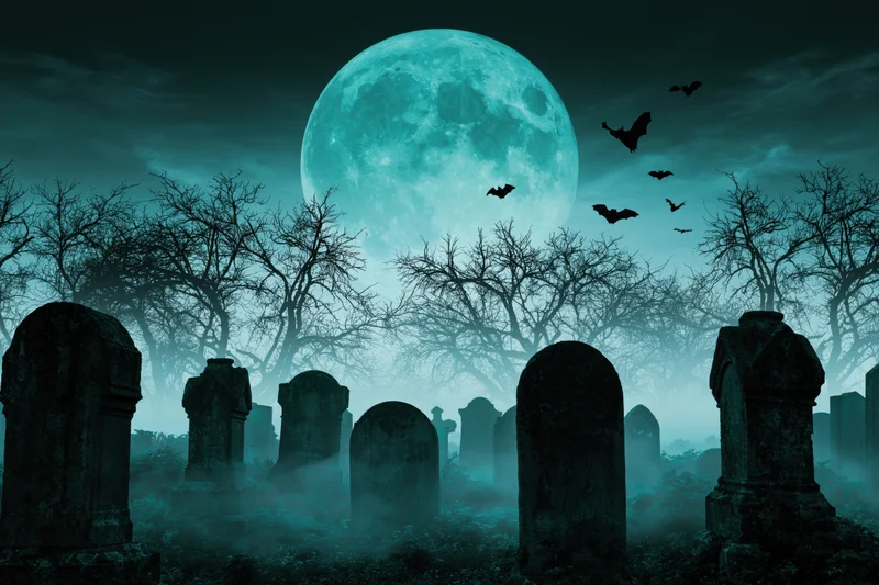 Old cemetery at night with weathered headstones and bare trees under a full moon, bats flying in the foggy sky