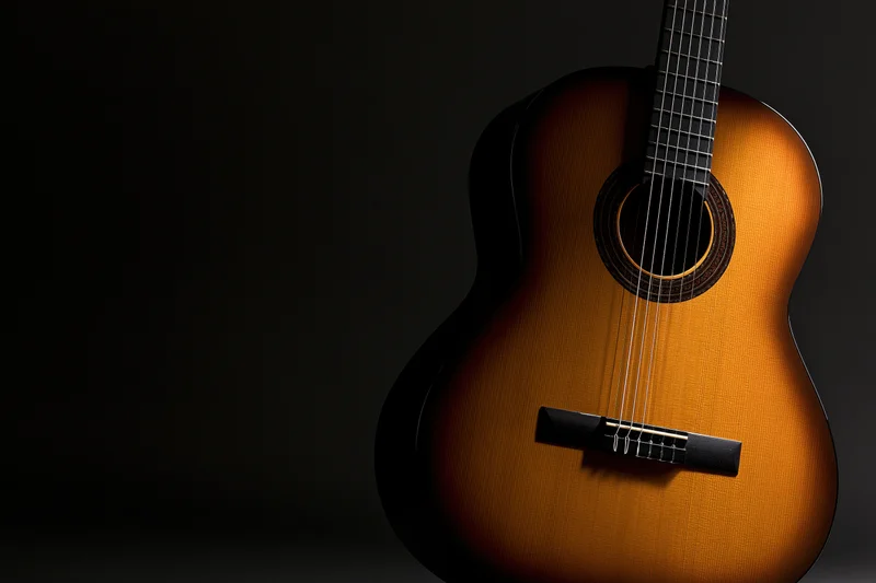 Classical acoustic guitar resting upright against dark background with copyspace on left